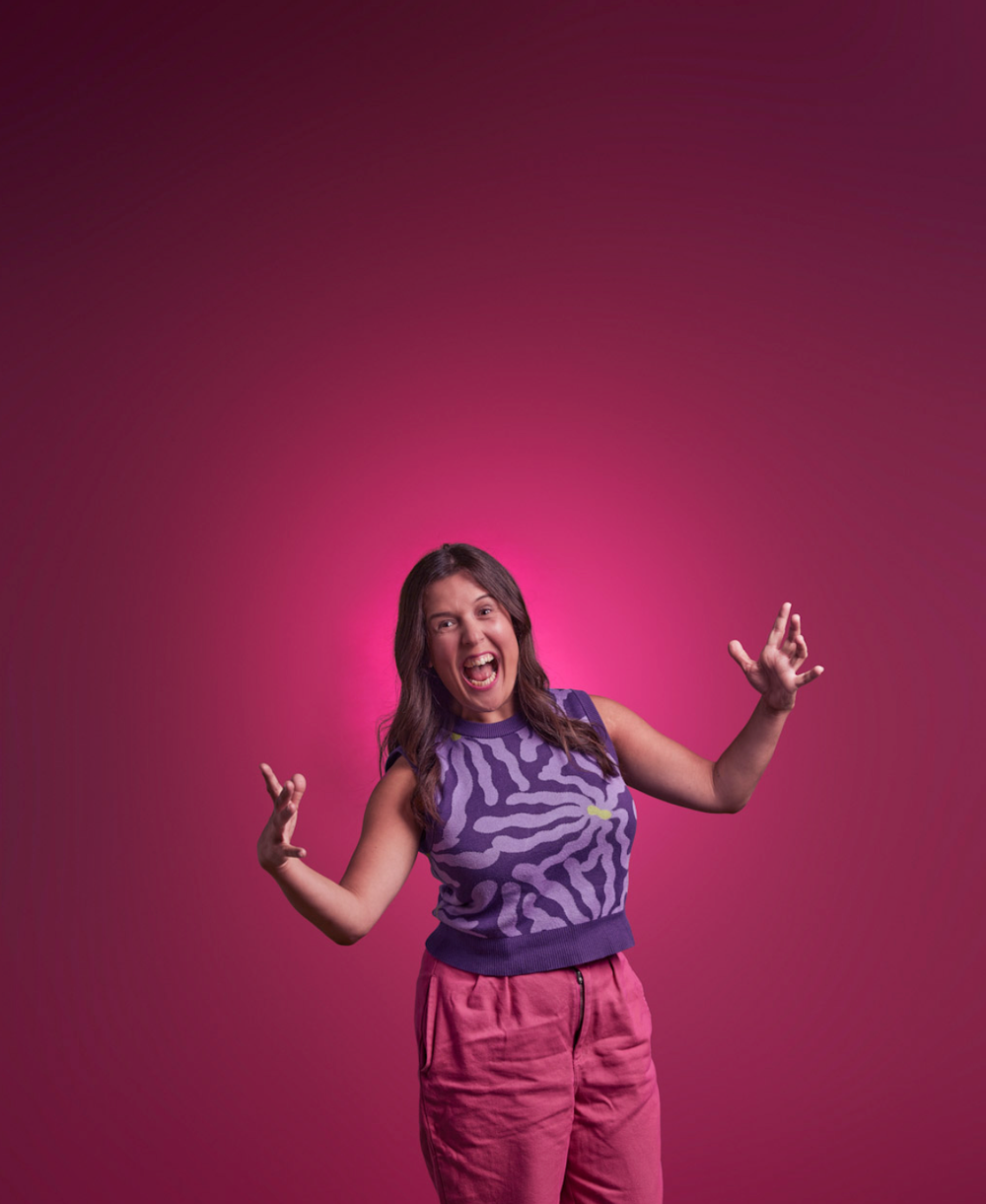 Person in purple scarf and pink pants showing energetic poses against magenta background.