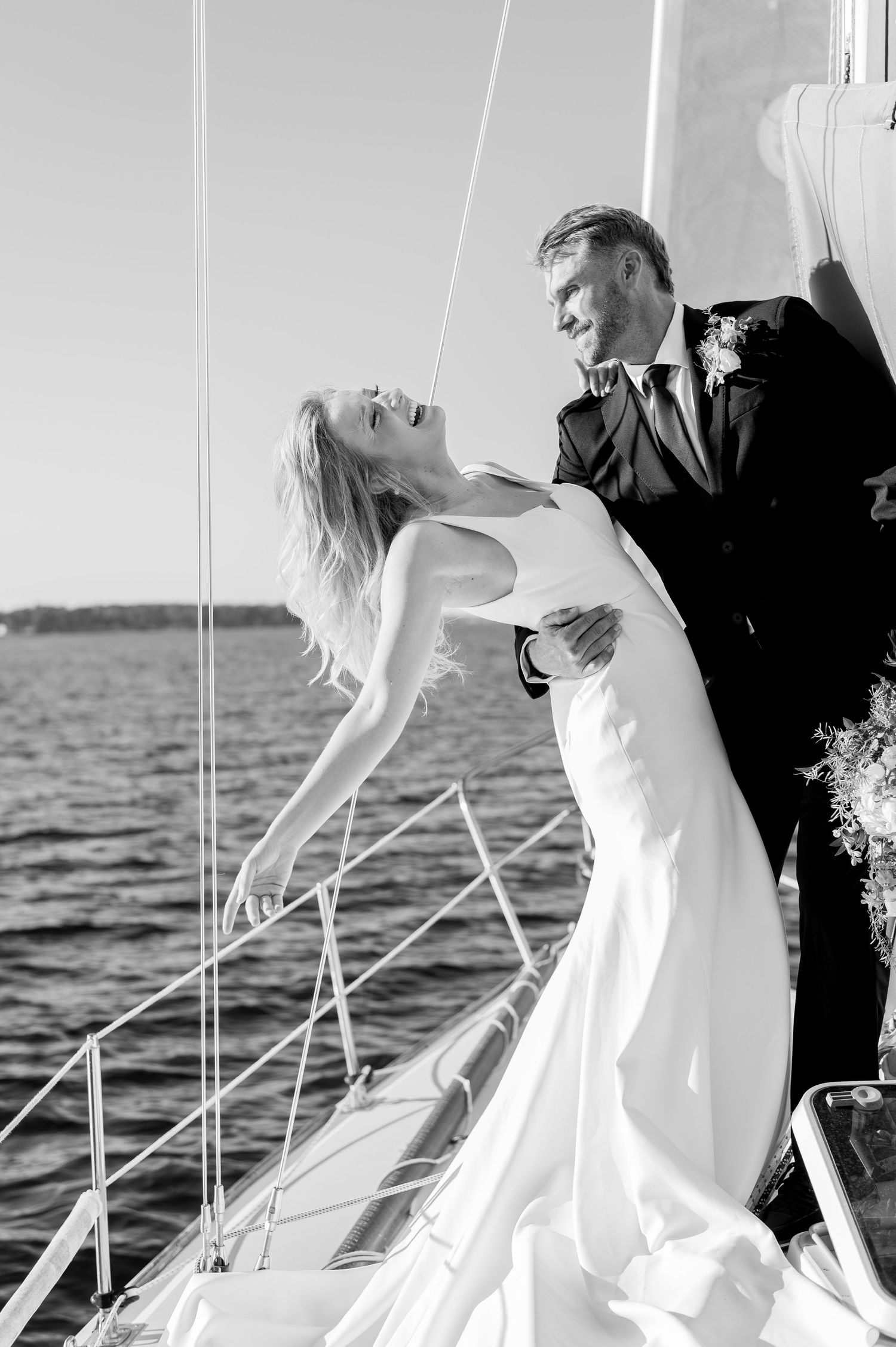 Black and white wedding photo sequence showing couple dipping and dancing together by the ocean at sunset.
