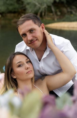 Tender moment captured between couple in romantic outdoor setting.