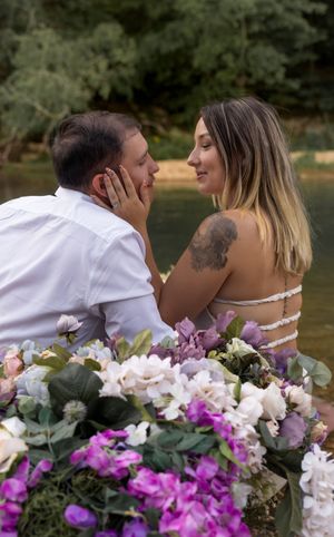 Intimate lakeside moment captured with stunning purple and white floral display in foreground.