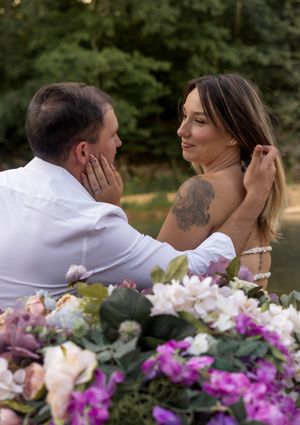 Tender moment captured in boat with gorgeous purple and white floral decorations.