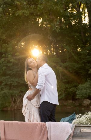 Romantic sunset photoshoot on a small boat decorated with delicate flowers.