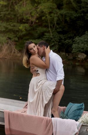 Romantic boat photoshoot with delicate floral arrangements and soft evening light.