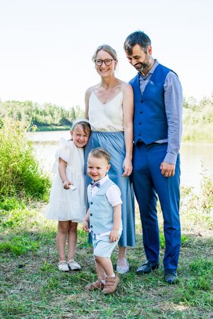 Candid family moments captured in a sunny outdoor setting with light summer attire.