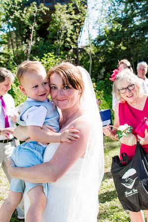 Wedding celebration photos with guests and family members gathered in sunny garden setting.