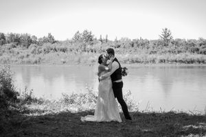 Black and white wedding photographs showing romantic moments by a lakeside.