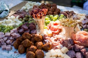 An elegant wedding reception buffet displays various appetizers and hors d'oeuvres.