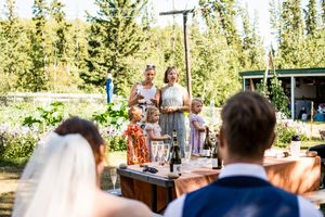 A series of wedding celebration photos showing guests dancing and enjoying festivities at an outdoor reception venue.