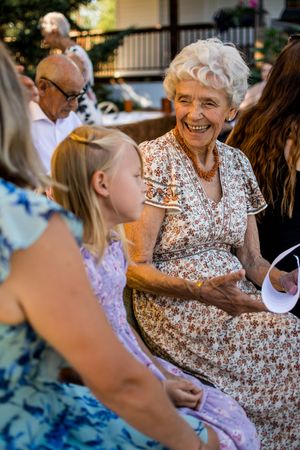 Wedding guests enjoying a cheerful moment during an outdoor summer celebration.