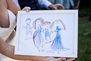 Children's drawings displayed on white paper showing wedding-themed illustrations.