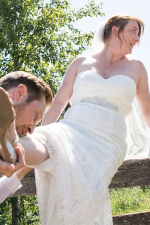 Series of romantic wedding photos showing couple in white dress and suit posing by a rustic tree branch.