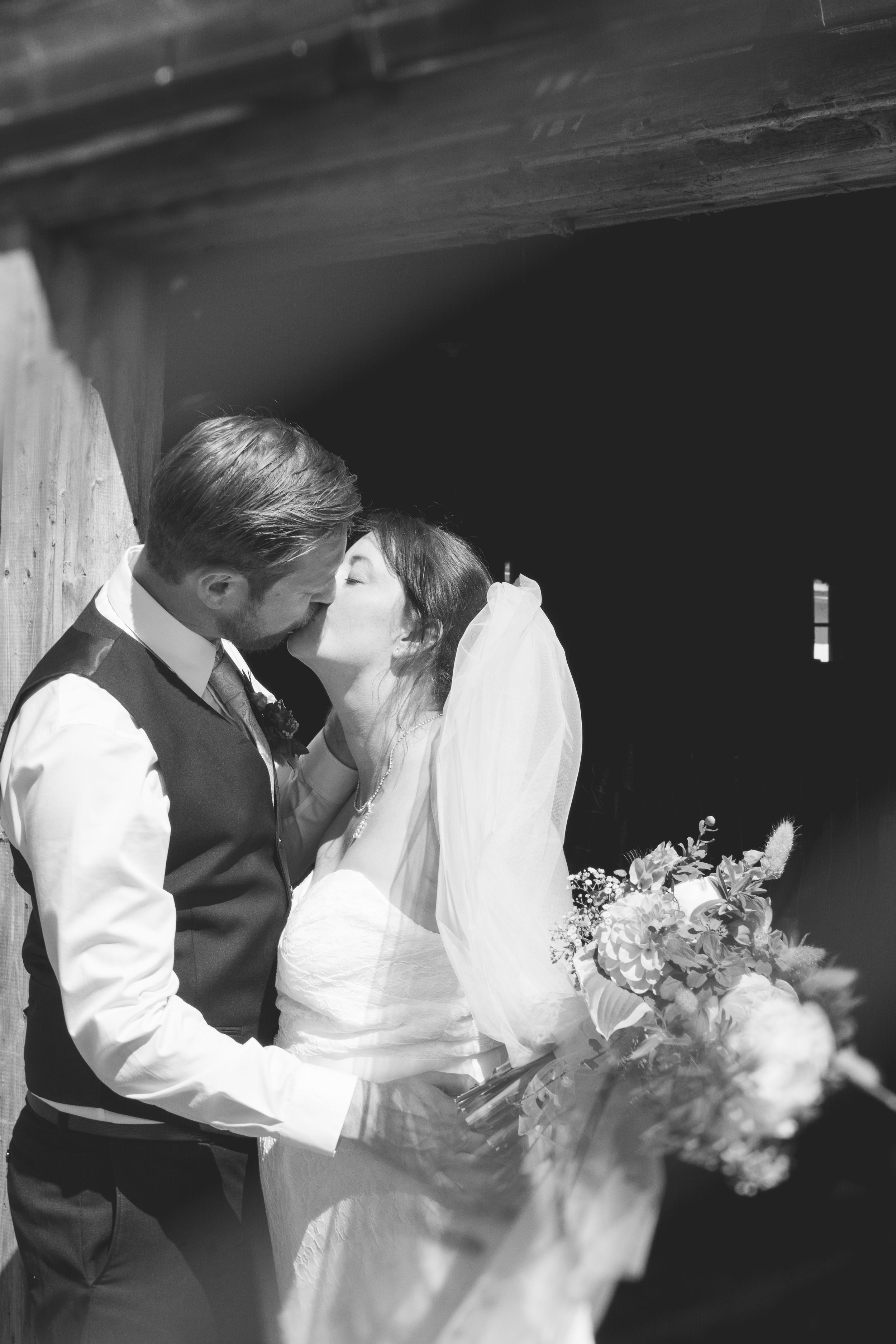 A series of black and white wedding photos showing tender moments between newlyweds.