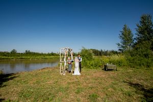 Panoramic view of a rural wedding venue against bright blue sky.
