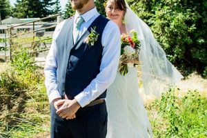 A wedding ceremony takes place in a lush garden setting with decorative floral arrangements.