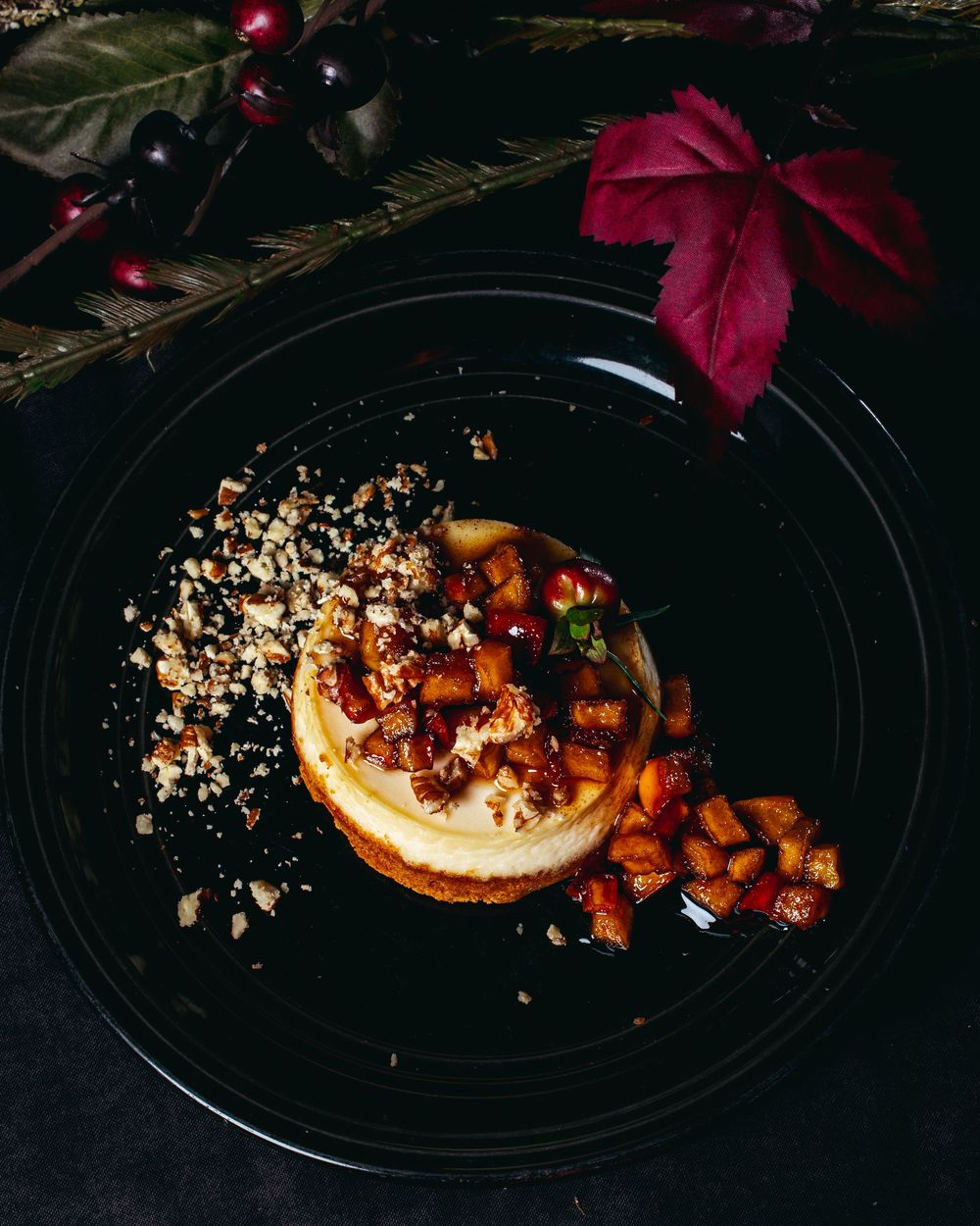A step-by-step sequence showing the plating of a dessert with crumble topping and caramelized elements on a dark plate.