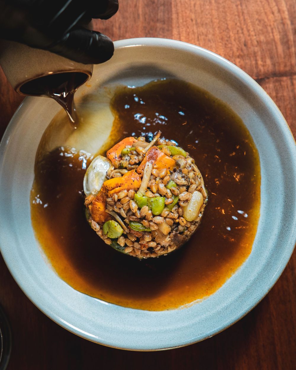 Asian-inspired dish with rice and sauce served in a white ceramic bowl.