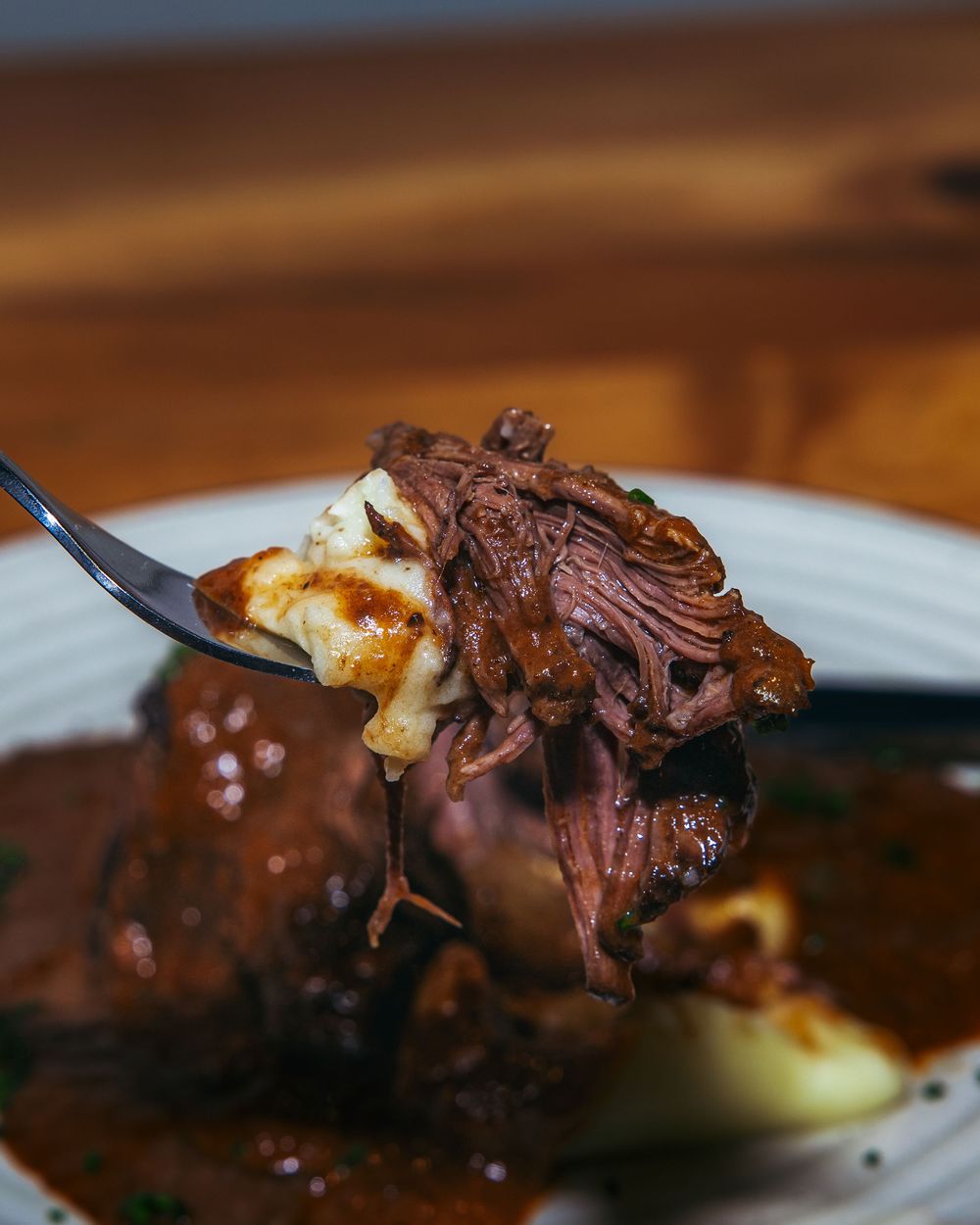 Close-up sequence of chocolate-covered marshmallow being cut with a fork showing gooey texture and rich coating.