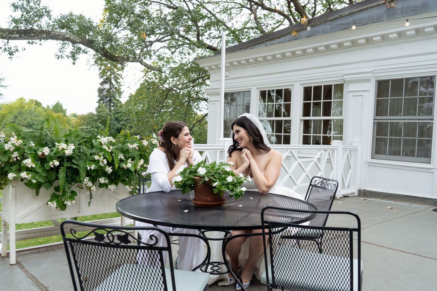 Candid image of a Lesbian wedding couple at a table