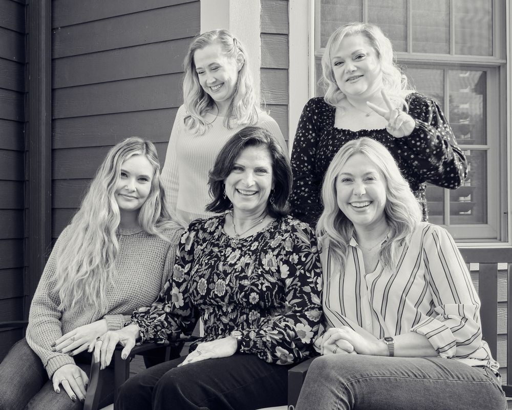 Black and white photo series showing candid moments of people laughing and interacting on a porch.