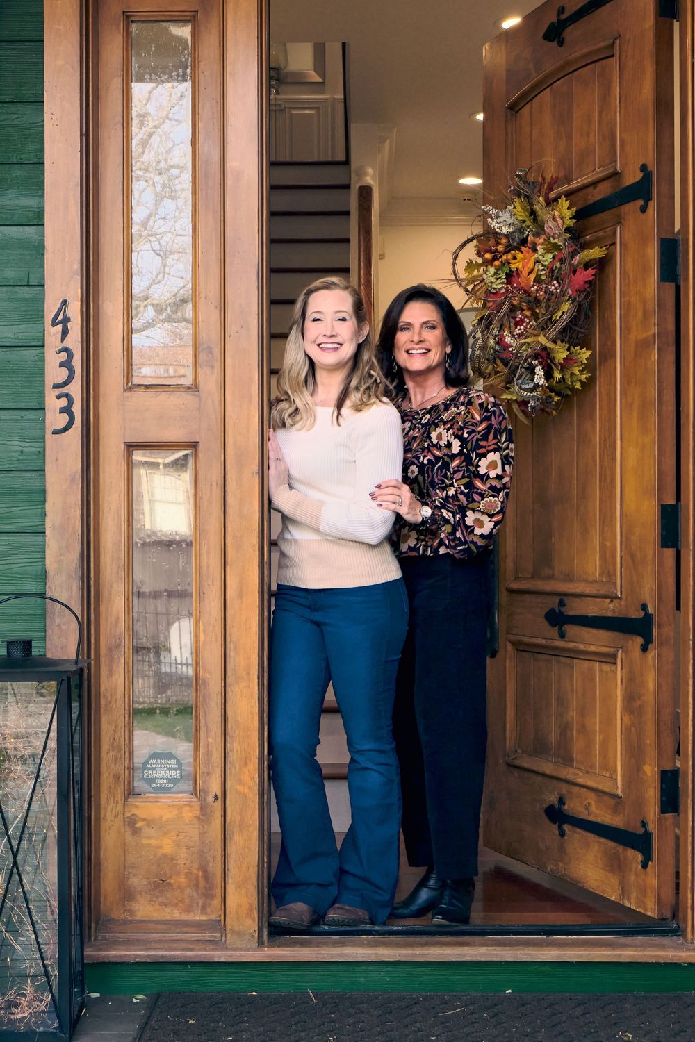 Two people pose together in a series of three photos on a porch with green trim and wooden doors.