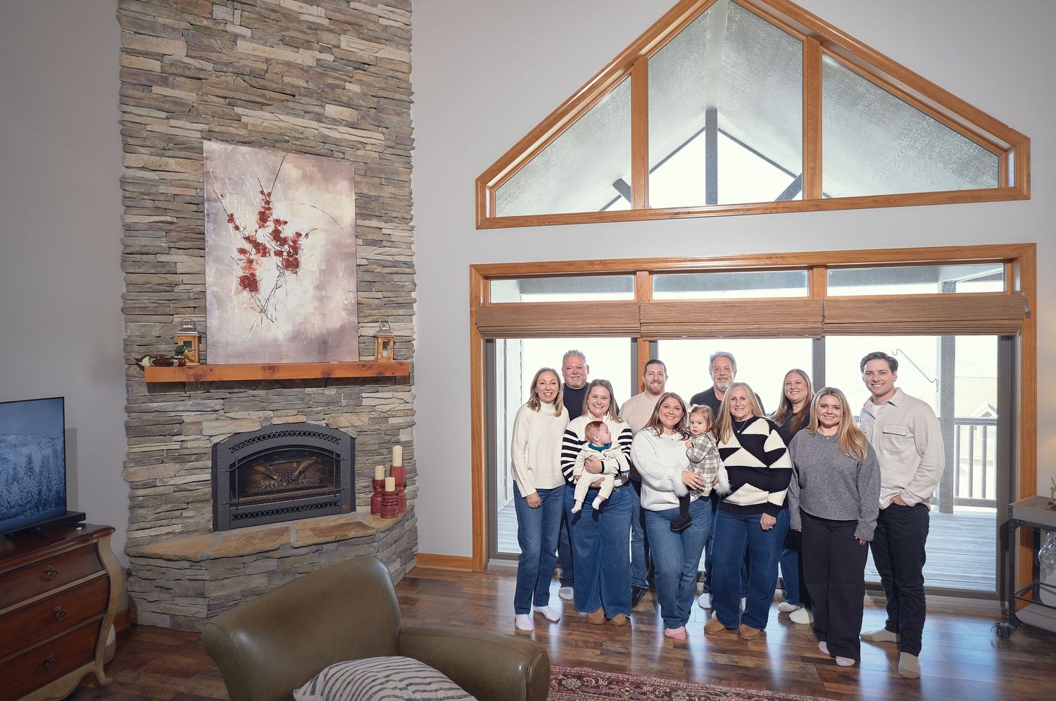 A sequence of interior photos showing a modern room with stone walls, large windows, and wooden trim details.