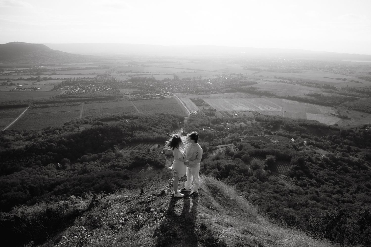 Black and white aerial landscape photos showing mountainous terrain and valleys with scattered settlements.