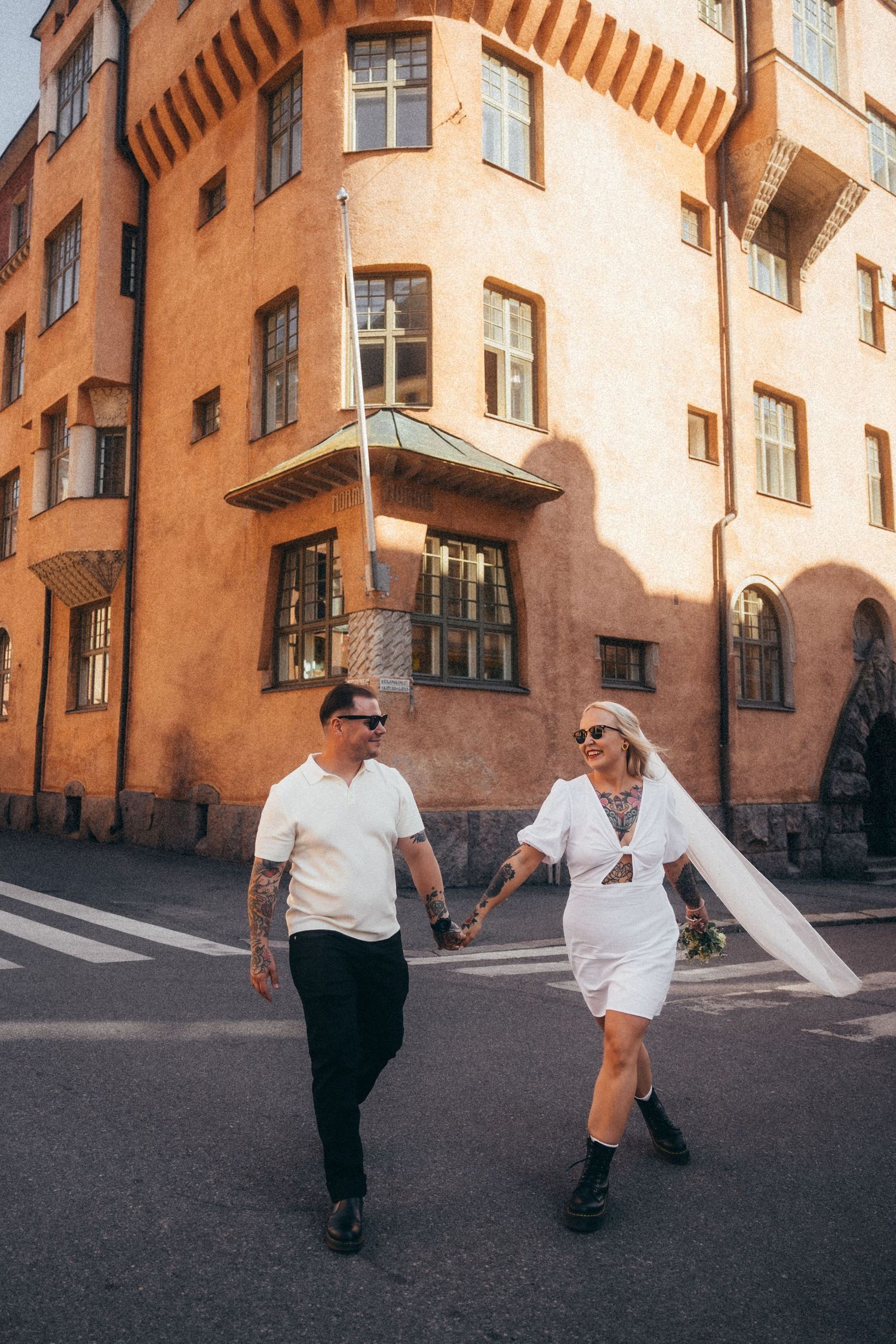 A sequence of four street photos showing two people dancing and interacting on a city street with orange buildings.