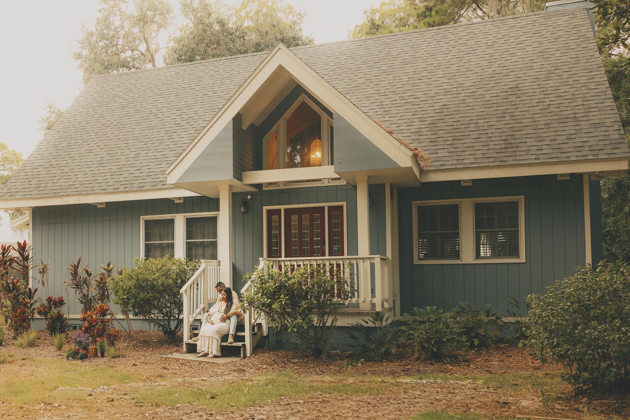 A series of exterior views showing a gray residential house with sloped roof and landscaping in different lighting conditions.