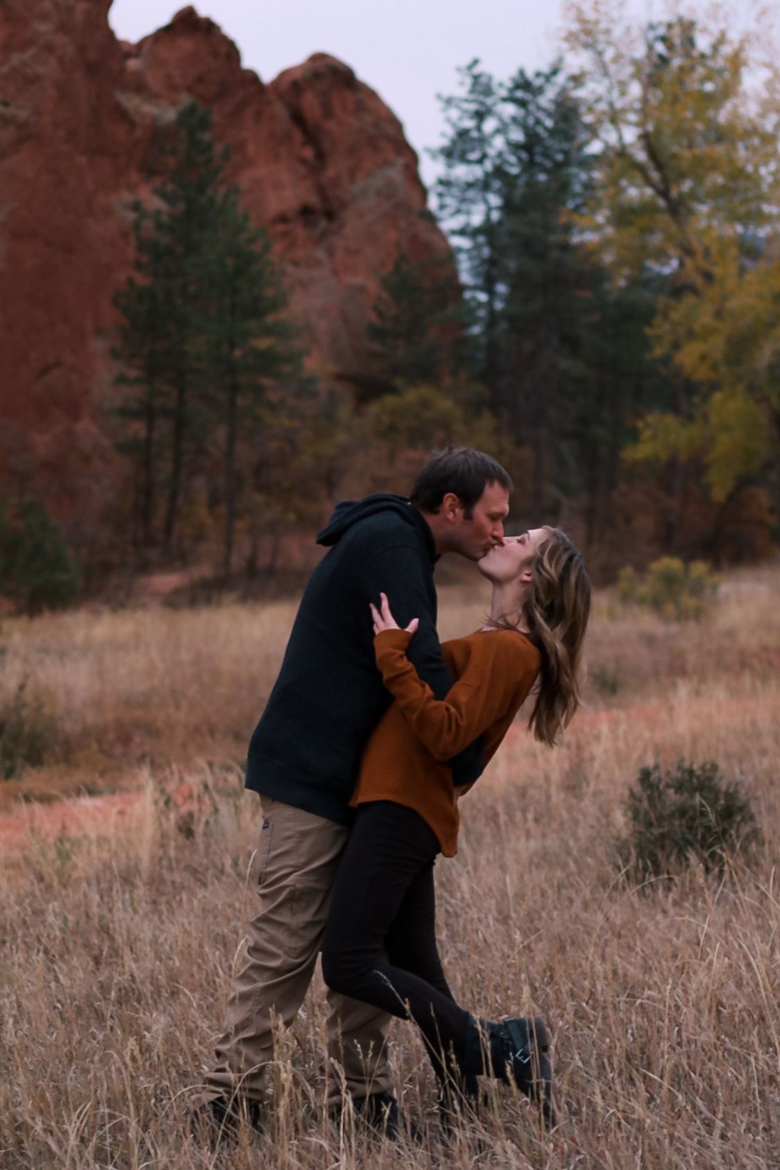 happy kissing couple in a field