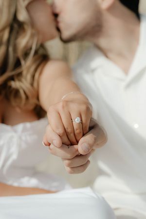 Close-up sequence of a hand with a diamond engagement ring in soft natural light.