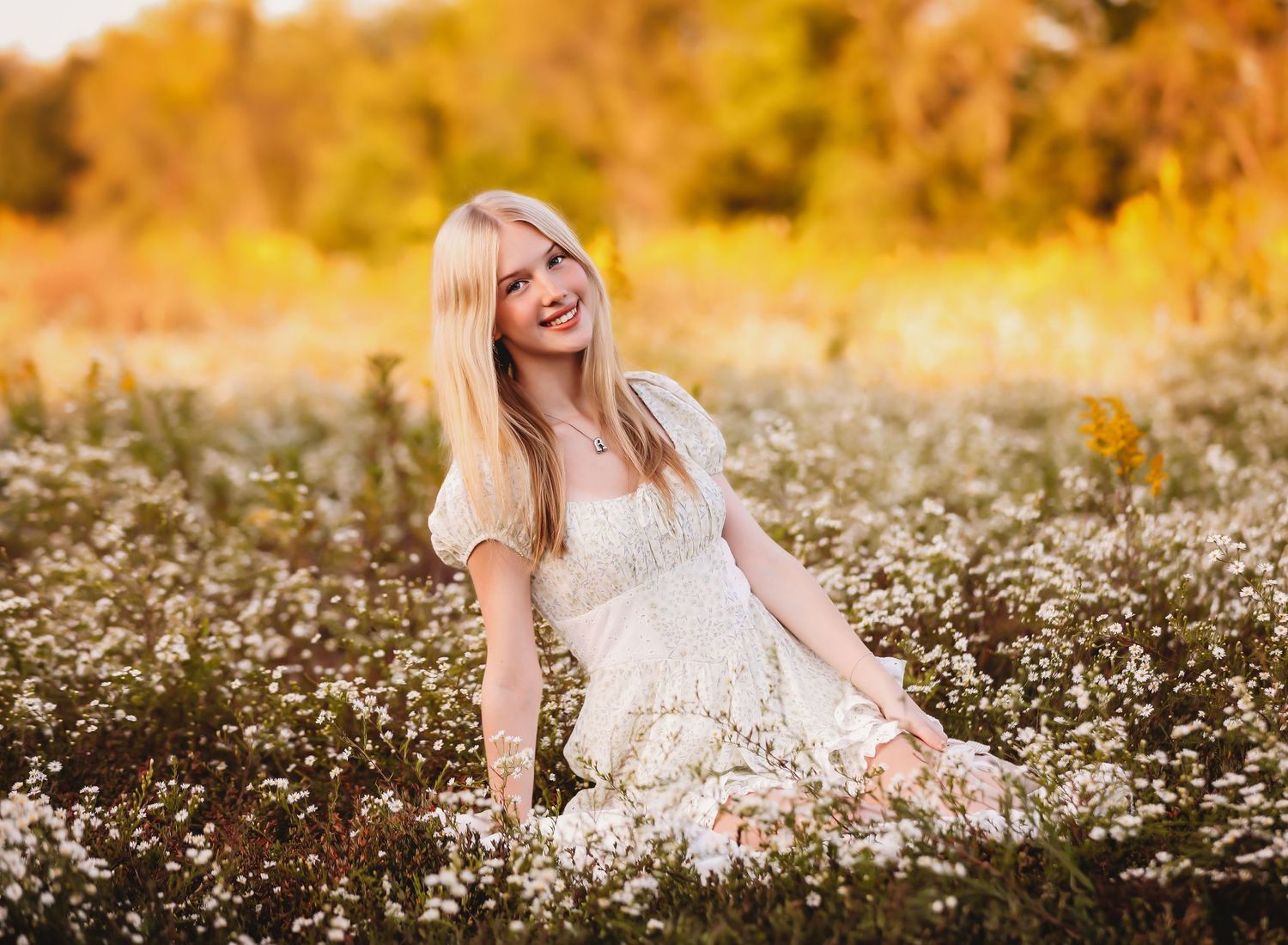 Girl in white dress twirling in field of wildflowers at sunset.