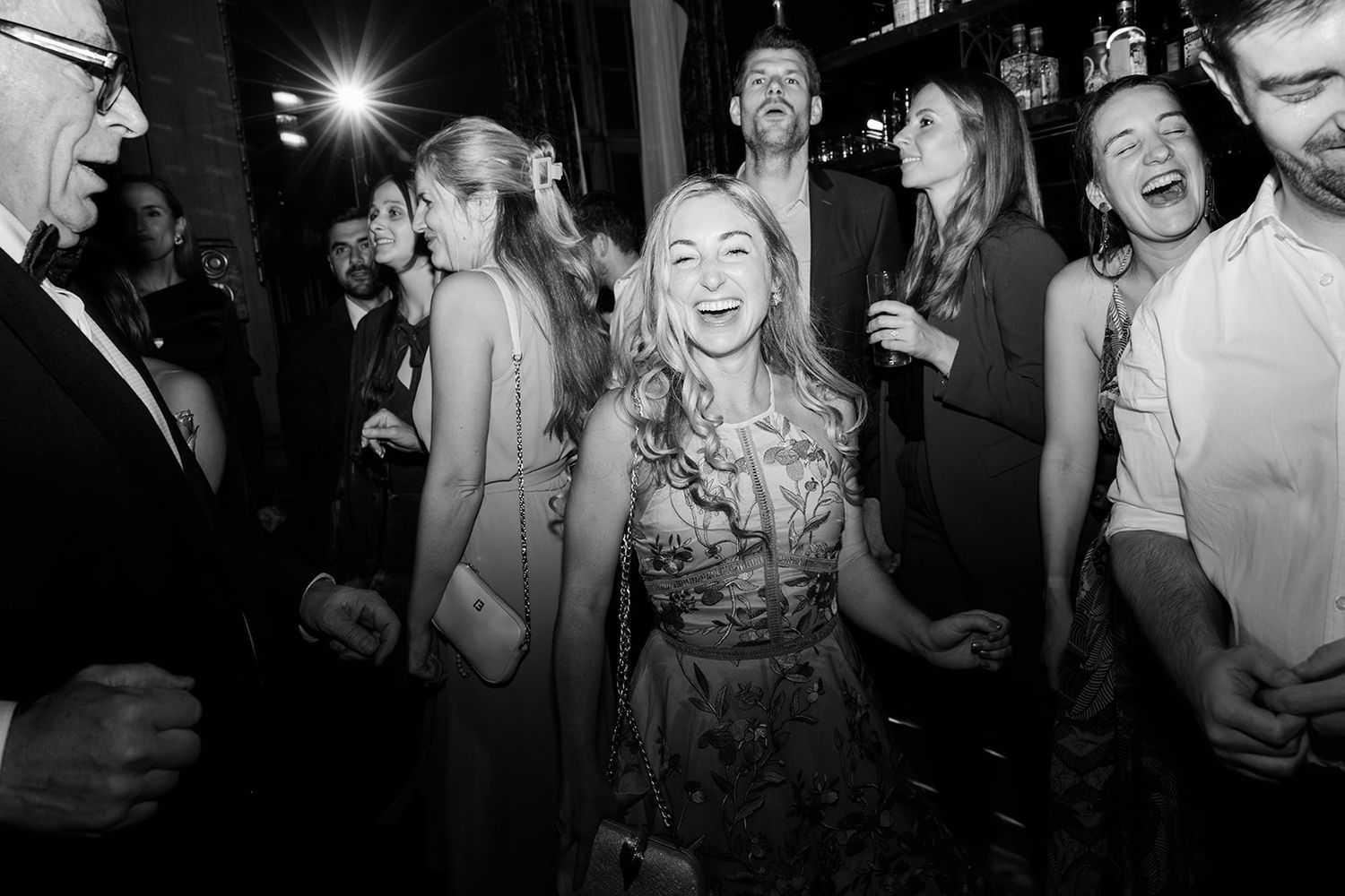 People dancing and enjoying themselves at a nightclub or party in black and white photography.