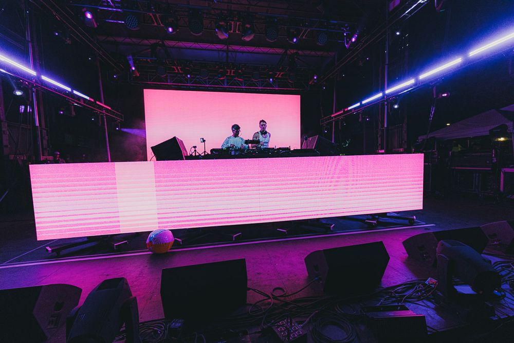 Modern event space with purple and pink LED lighting creating a futuristic ambiance.