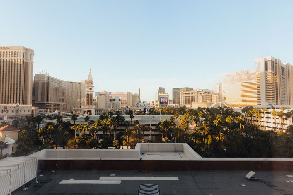 Panoramic cityscape view of urban buildings against a clear blue sky.