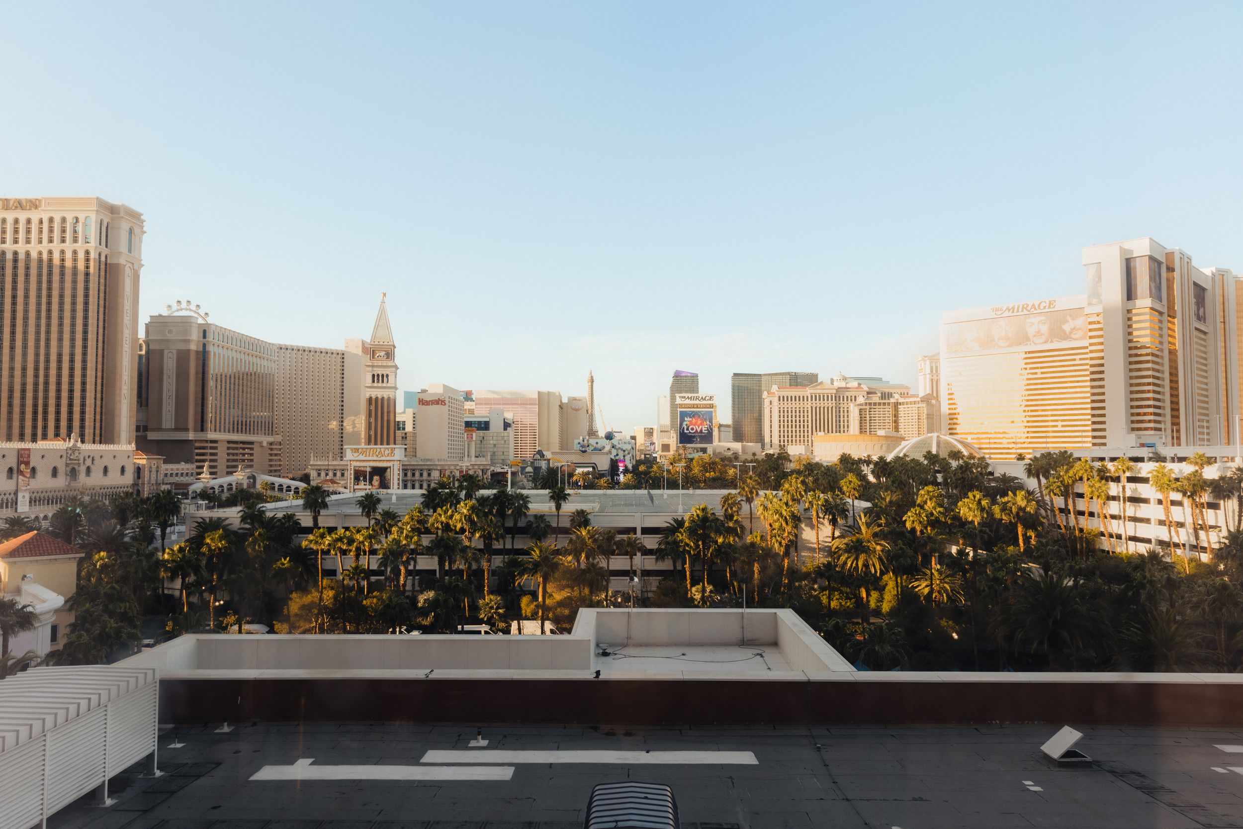 Panoramic cityscape view of urban buildings against a clear blue sky.