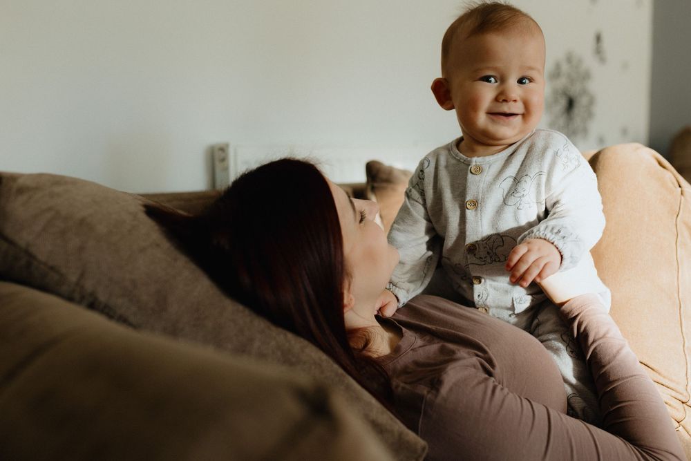A series of tender parenting moments captured in warm, intimate photographs showing gentle interactions and care.