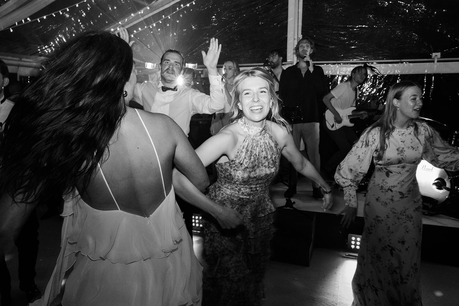 Black and white photos show people dancing and celebrating at what appears to be a wedding reception or party.