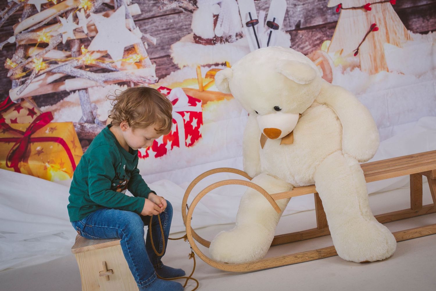 A sequence of photos showing the process of stuffing and assembling a large teddy bear in a craft workshop.