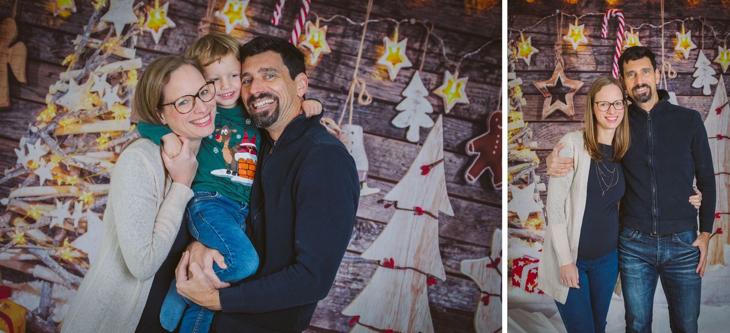 A couple shares a romantic moment together in front of a wall decorated with colorful lights and decorations.