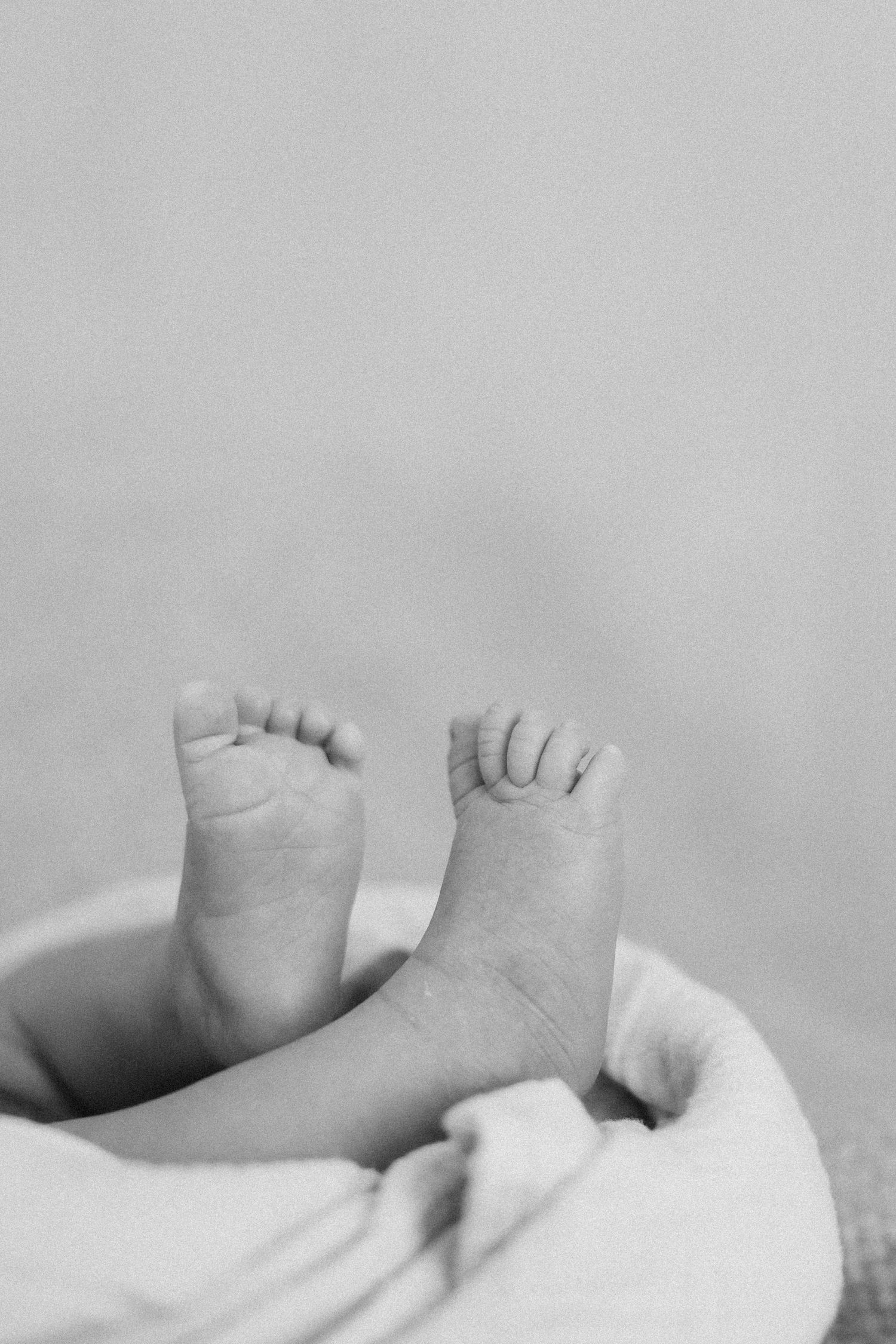 Orange County photographer capturing newborn toes and wrinkles in a lifestyle session