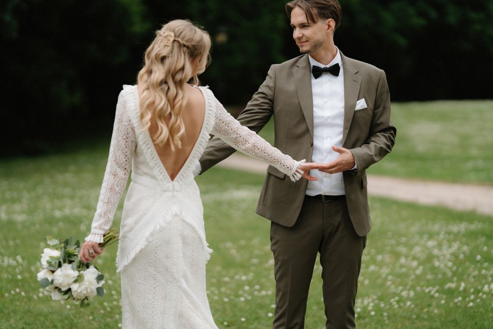 Wedding couple sharing a romantic moment in a flower-filled meadow on their special day.