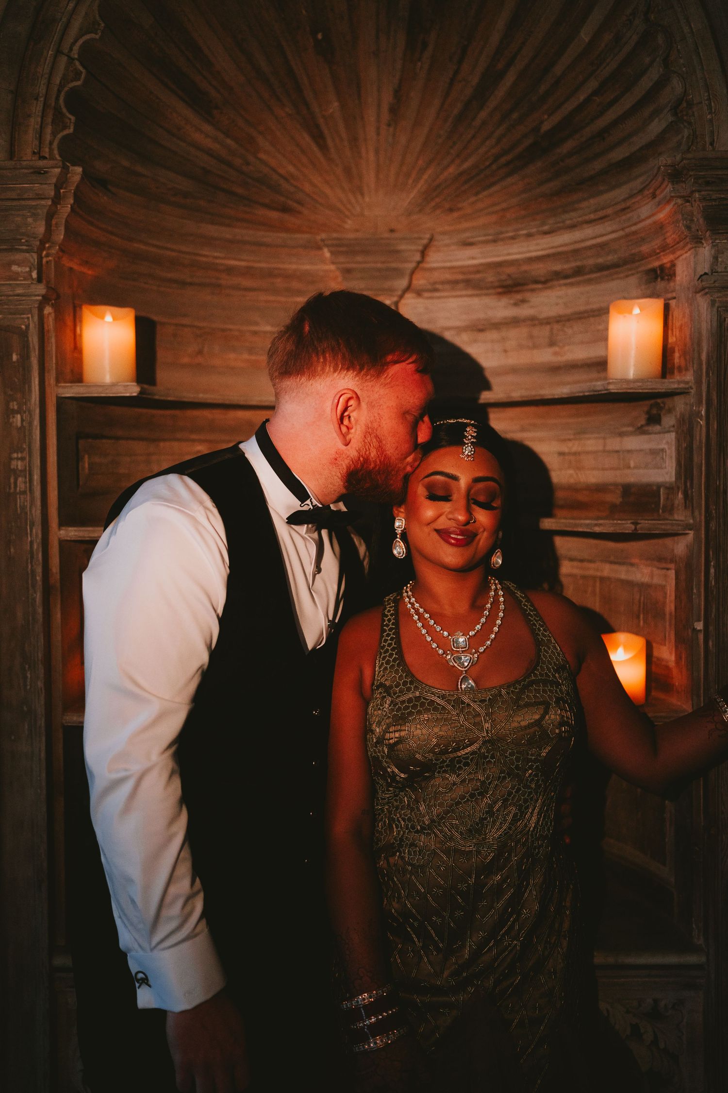 Romantic candlelit moment in rustic wooden setting.