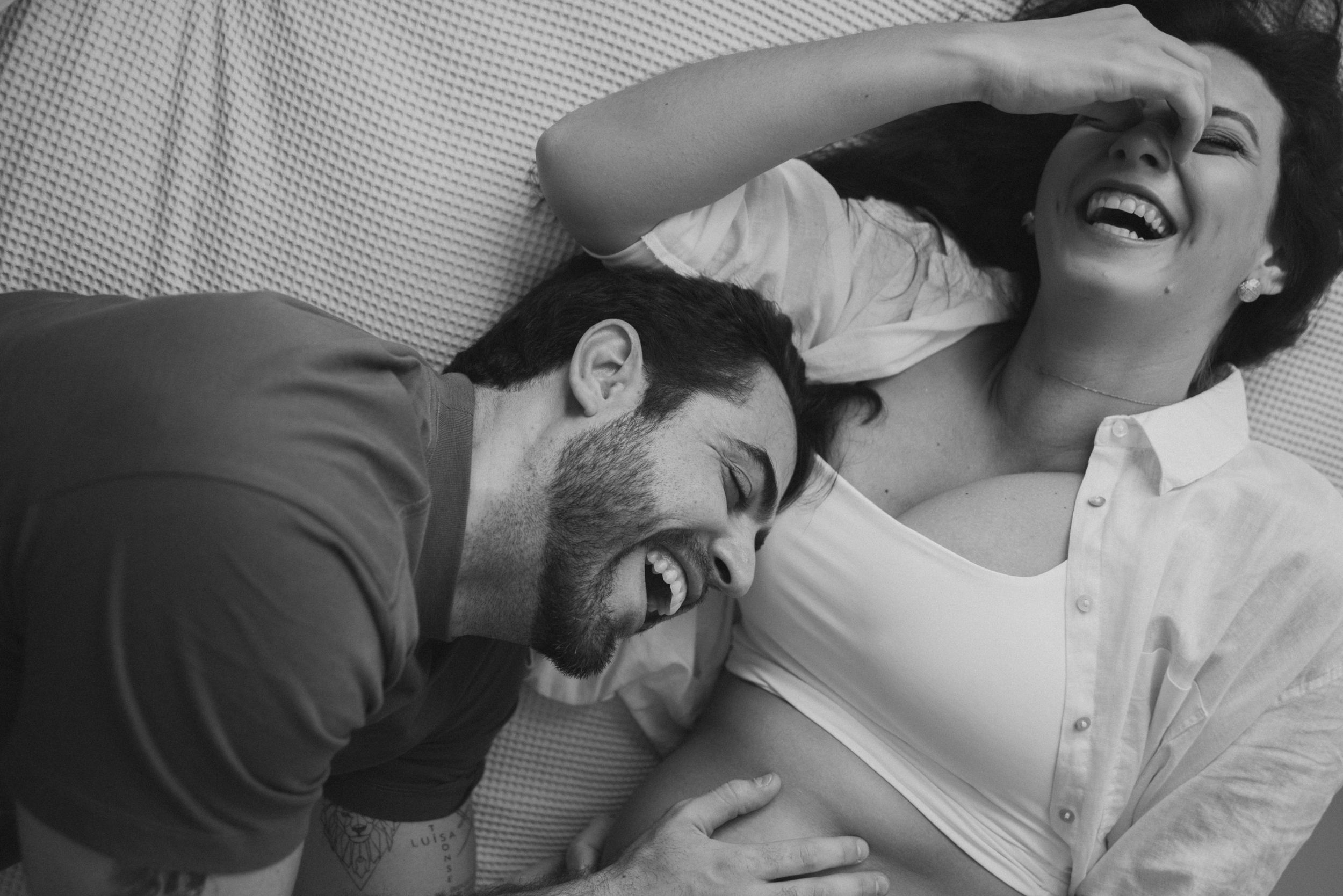 Black and white intimate photo of couple sharing joyful moment.