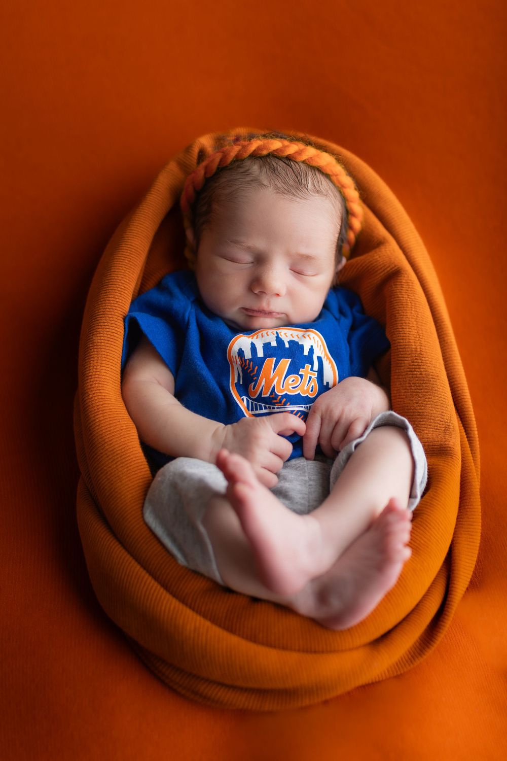 Southeast Michigan Newborn indoor session. In Daddy's baseball team outfit.