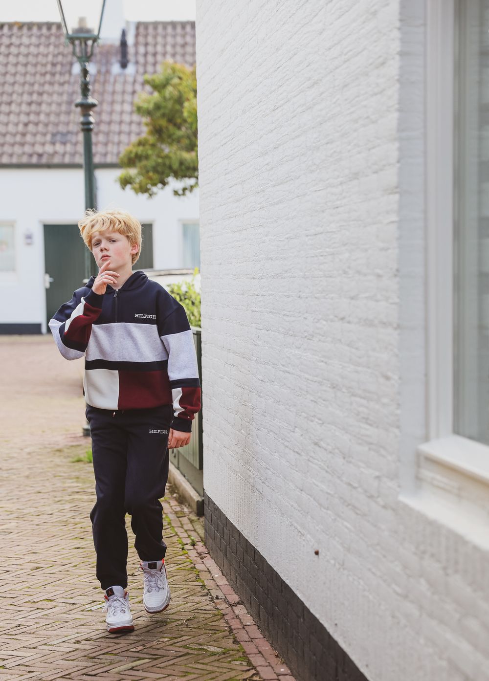 A casual street scene with modern architecture and brick walls.