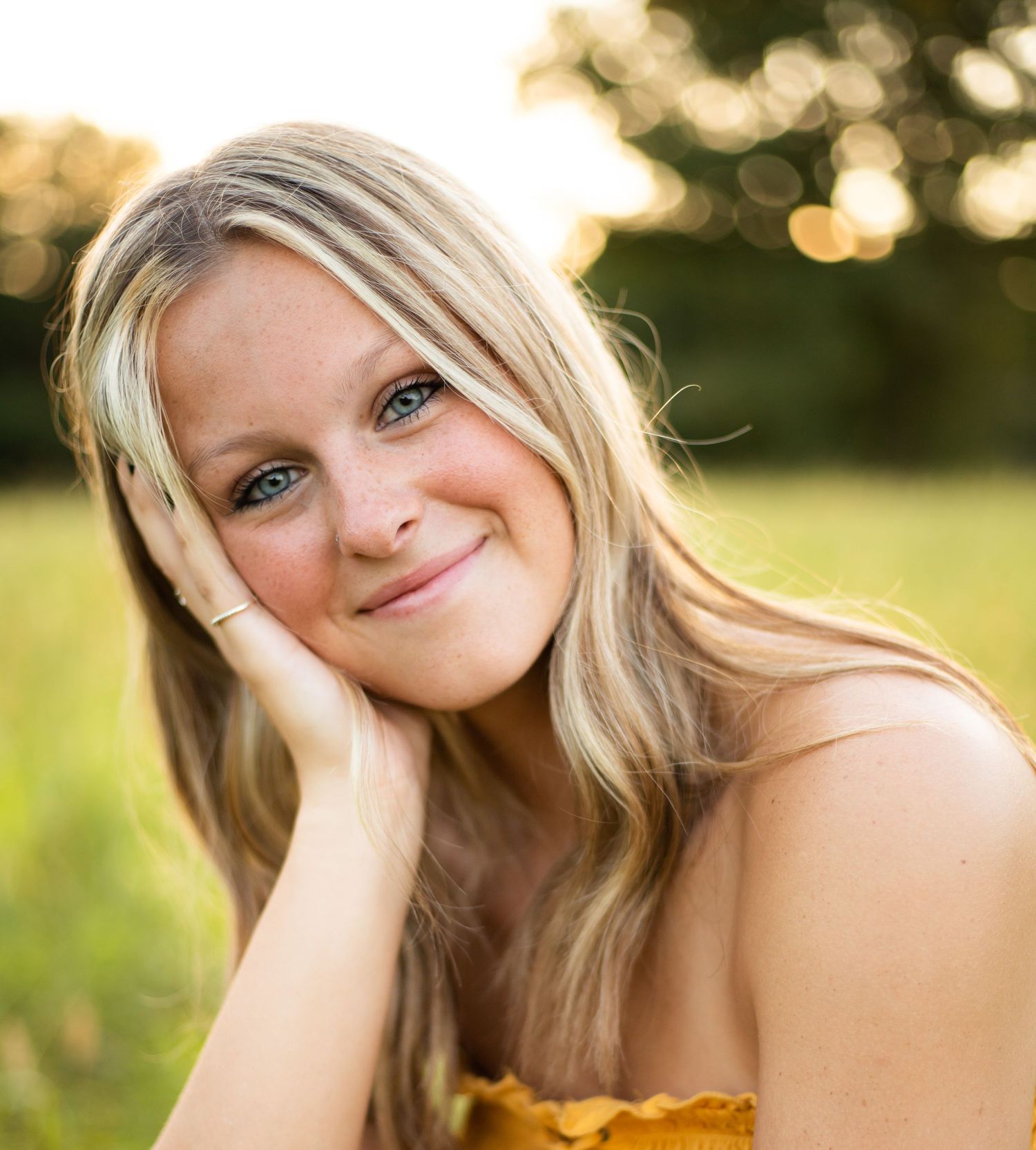 Portrait series of a young woman in golden sunlight with natural poses.
