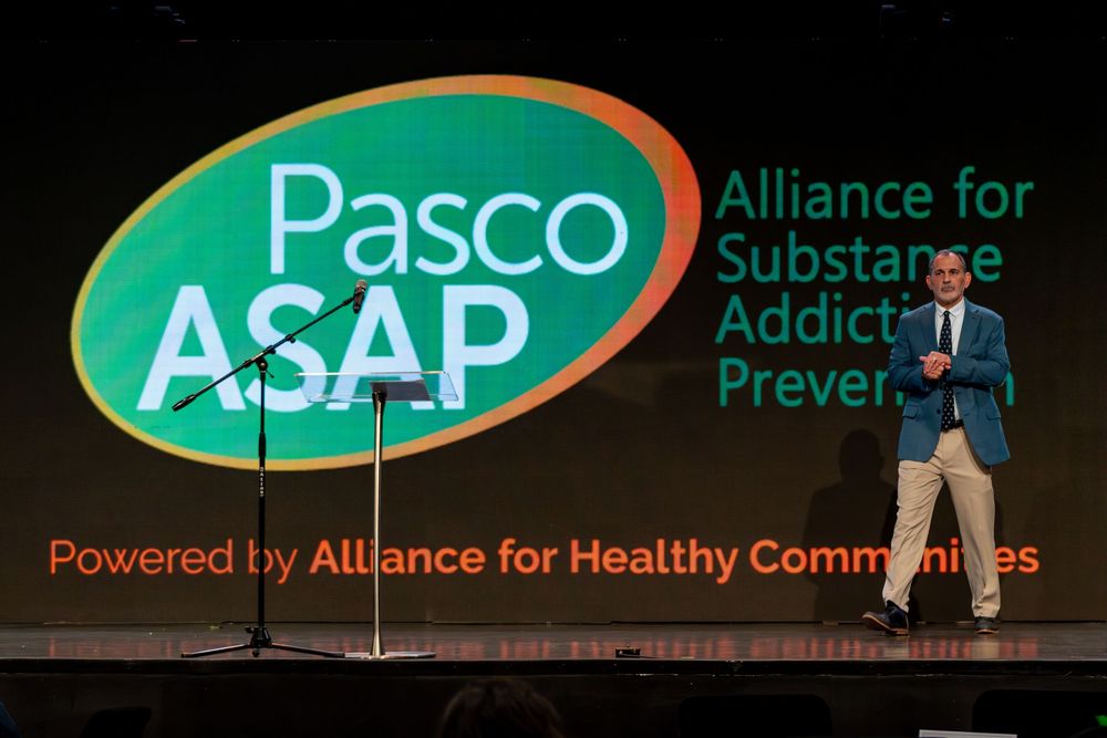 Green event banners for Pasco Alliance and ASAP organizations displayed against dark background.