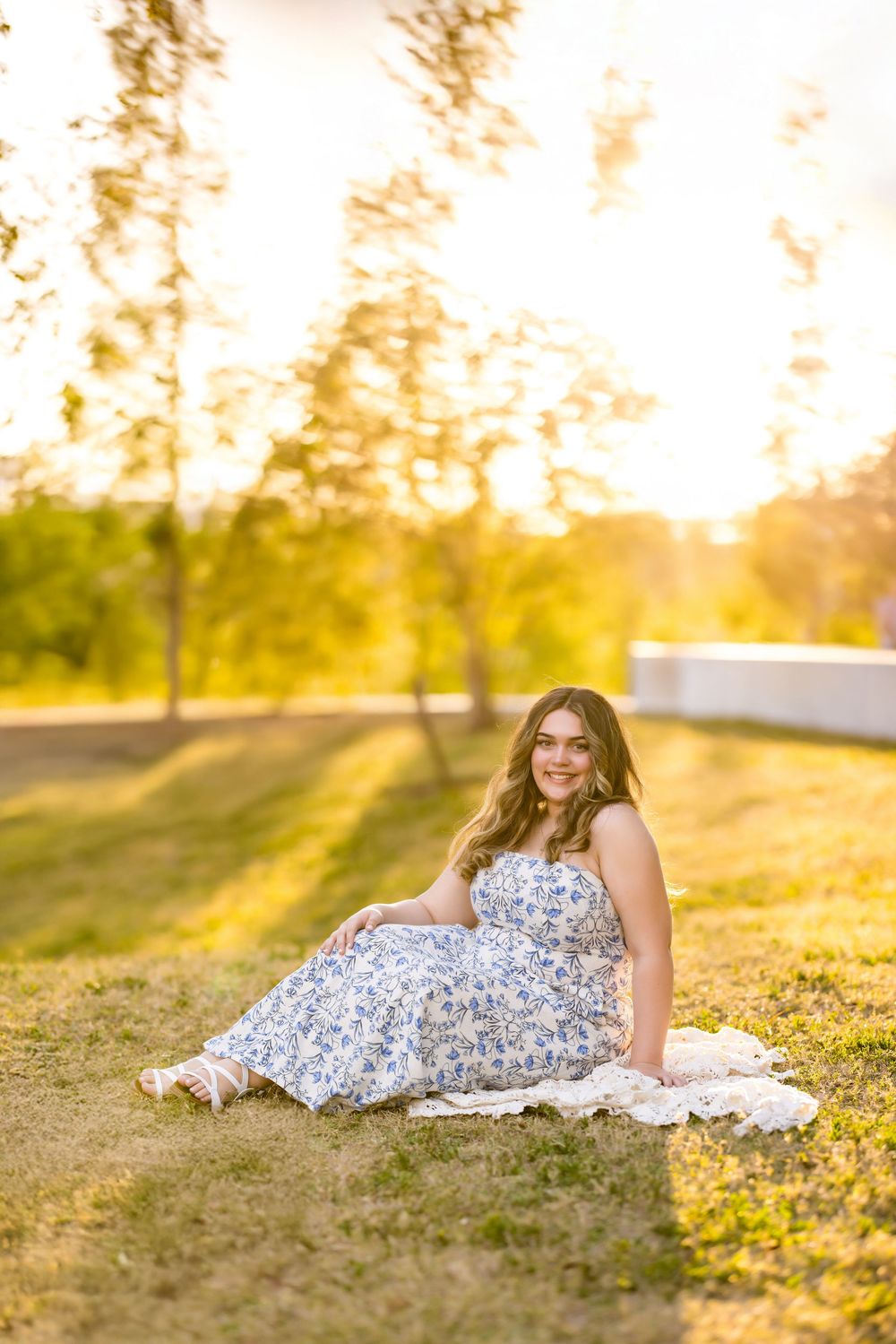 A dreamy sunset photoshoot on grass wearing a flowing white and blue dress. Photos by Tampa Photographer DigitalMyst Photography