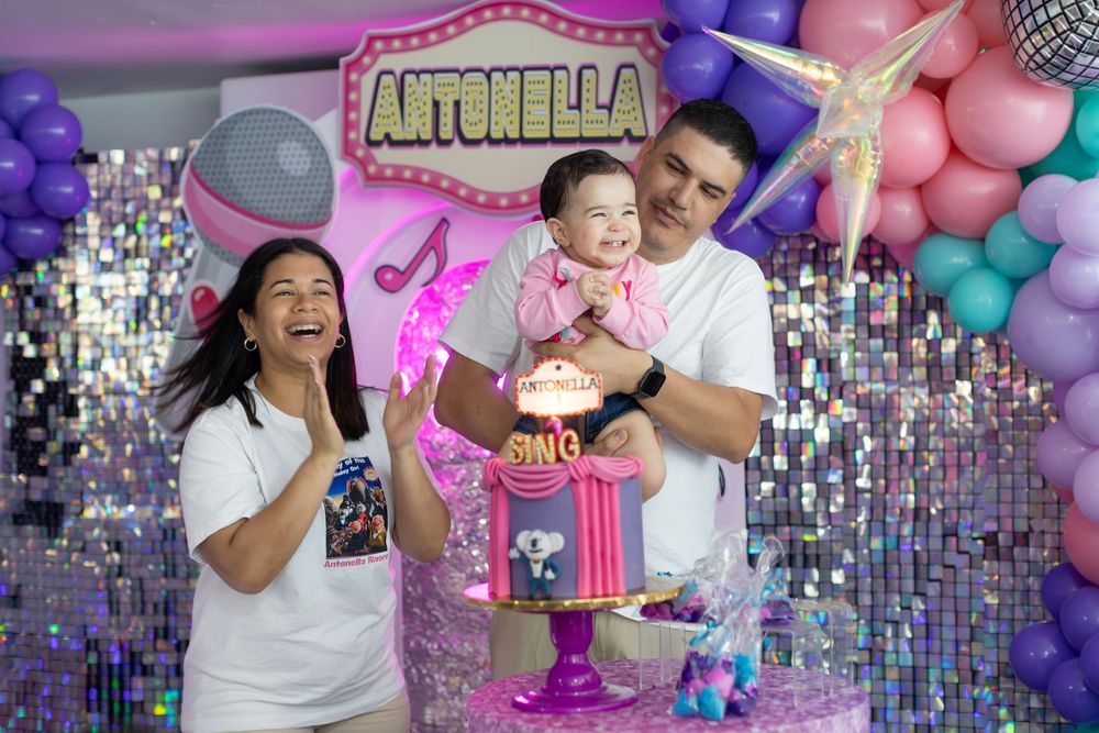 SING themed celebration backdrop with silver sequins and pink and purple balloon arrangements.