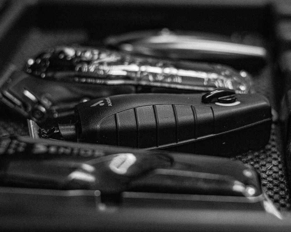 Collection of professional barber tools and equipment arranged in black and white.